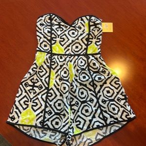 Reverse romper, black, white and neon green. Size small. Never worn, tags on.